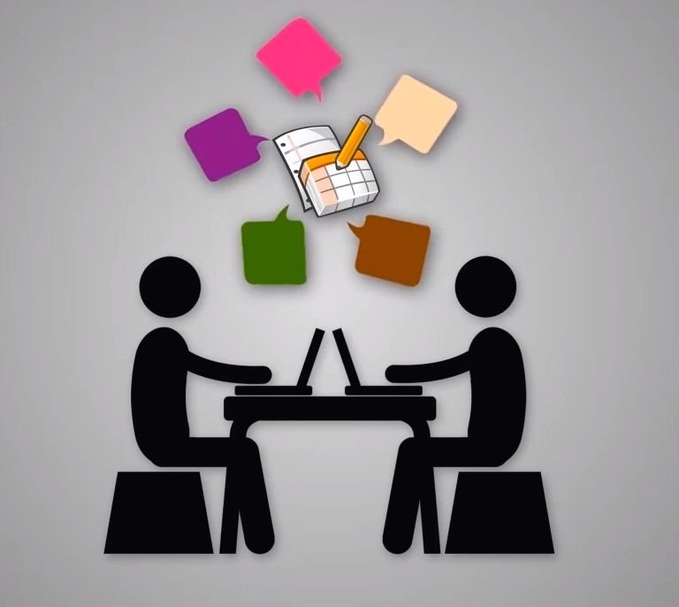 A desk with a laptop and a STEM infographic showing science, technology, engineering and mathematics icons